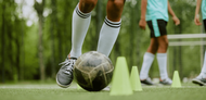 Football dribbling around cones